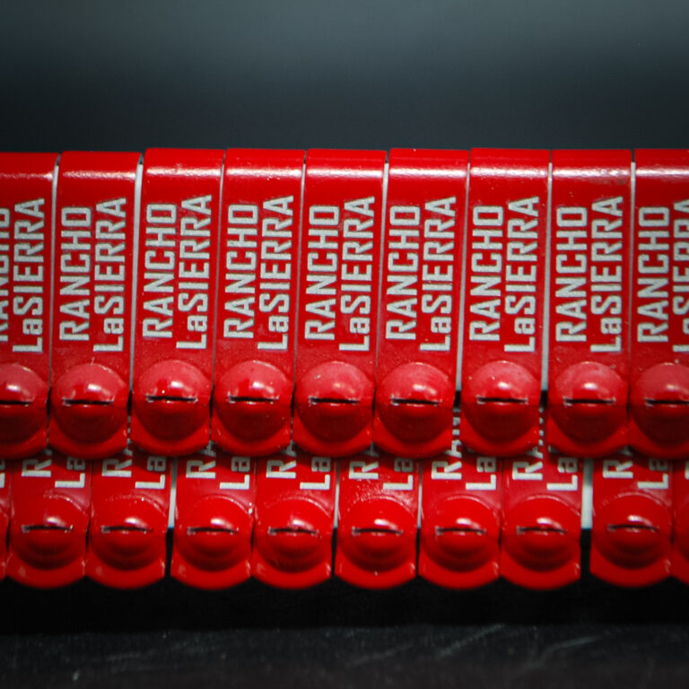 Red custom engraved JIFFY wing bands for Rancho Lasierra