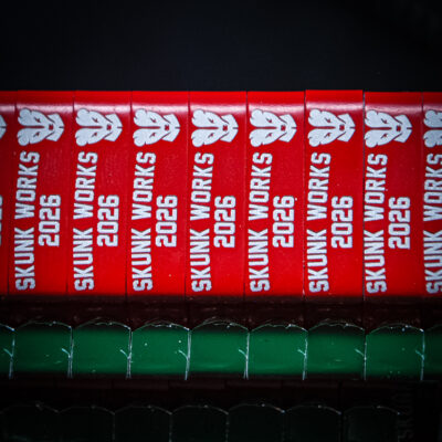 Red custom engraved ZIP wing bands for Skunk Works 2026